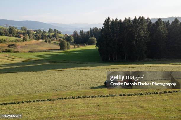 a farmer tills a field with a tractor - harrow on the hill stock pictures, royalty-free photos & images
