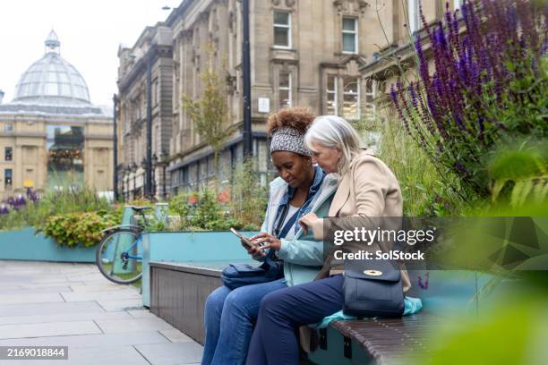 sitting down to navigate the city - side by side stock pictures, royalty-free photos & images
