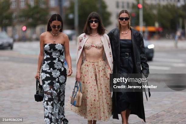 Anna Winter is seen wearing black semi-rimless sunglasses with rectangular lenses and thin metal temples from Ray-Ban, silver hoop earrings, a...