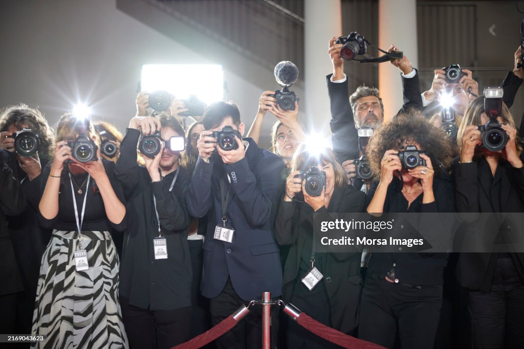 Paparazzi photographing at red carpet event