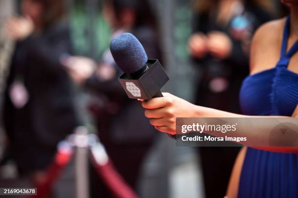 female media interviewer holding microphone - mike hand stock pictures, royalty-free photos & images