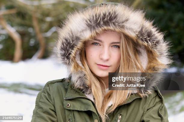 teenage girl wearing hooded parka outdoors - hairy-girl stock pictures, royalty-free photos & images