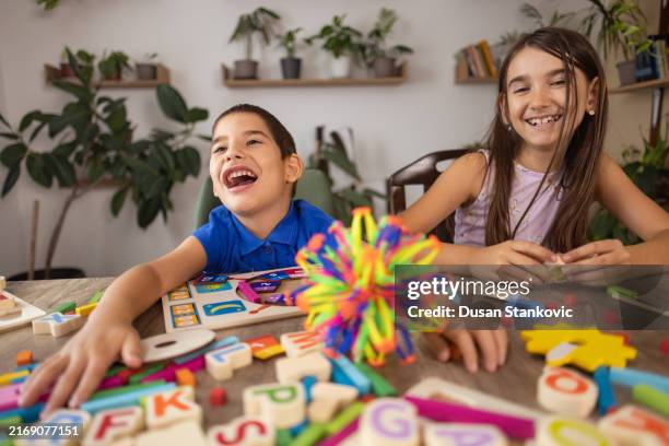 therapy with a smile - sibling stock pictures, royalty-free photos & images