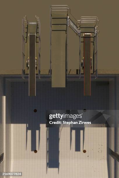 view from above diving platforms casting shadows over sunny, empty swimming pool - diving board pov stock pictures, royalty-free photos & images