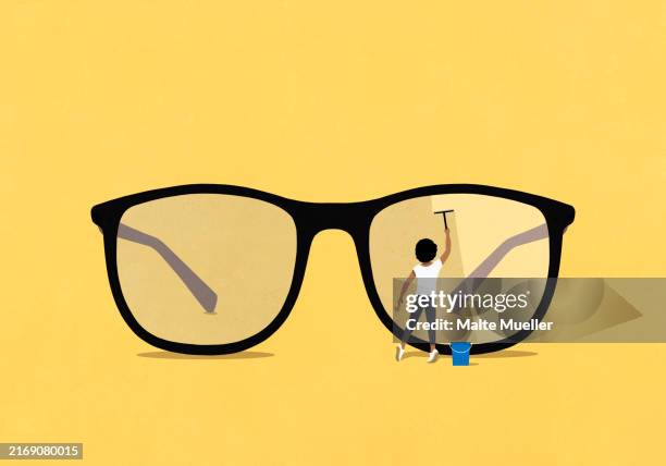 woman with squeegee cleaning lens of large eyeglasses on yellow background - brille stock-grafiken, -clipart, -cartoons und -symbole