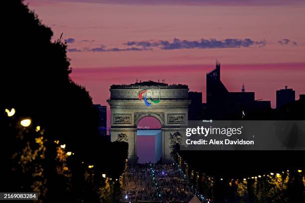 General view as the sun sets over the Arc de Triomphe whilst athletes enter the parade during the opening ceremony of the Paris 2024 Summer...