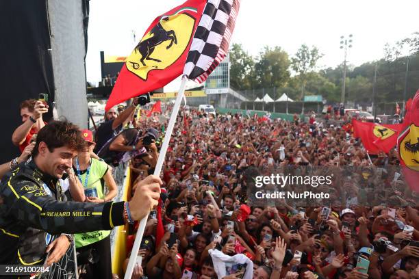 Charles Leclerc of Ferrari celebrates with fans after the Formula 1 Italian Grand Prix at Autodromo Nazionale di Monza in Monza, Italy on September...