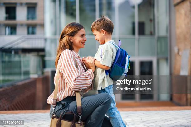 mother and son at school entrance for first day back to school - first day of school stock pictures, royalty-free photos & images