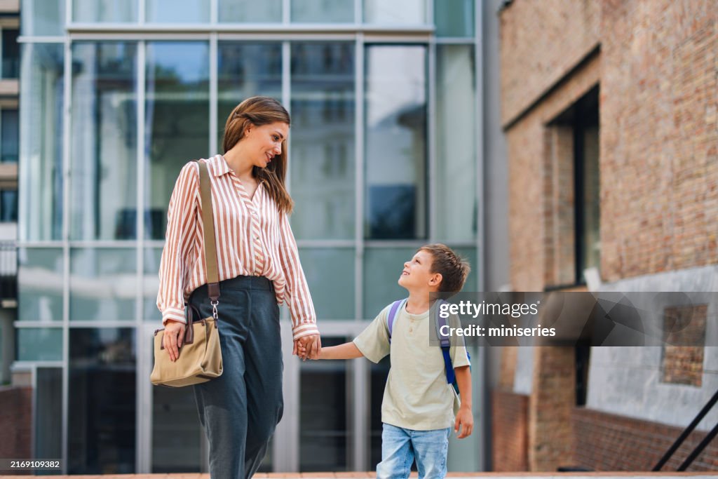 Happy Mother Walking Child to School on a Sunny Day