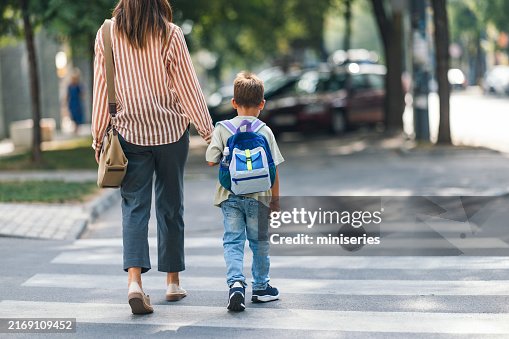 Mom Walking Son to Elementary School on First Day Back Mom Walking Son to Elementary School on First Day Back