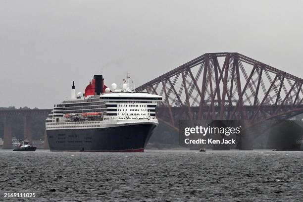 The Cunard line flagship Queen Mary 2 lies off North Queensferry, near the Forth Bridge, on September 1, 2024 in North Queensferry, Scotland.