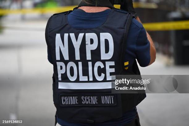 The New York Police Department investigates the scene of the shooting where a 37-year-old man was killed in Brooklyn, New York, United States on...