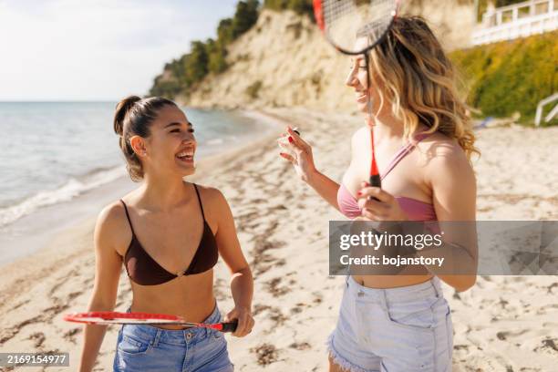 enjoying favorite hobby on the beach - badminton strand stock pictures, royalty-free photos & images