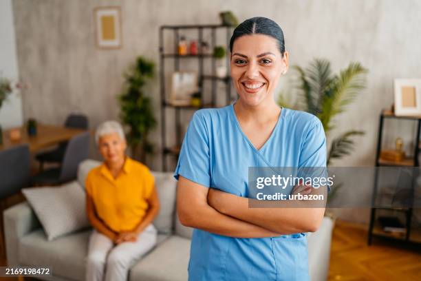 home care nurse visiting a senior woman at her home - balkans stock pictures, royalty-free photos & images