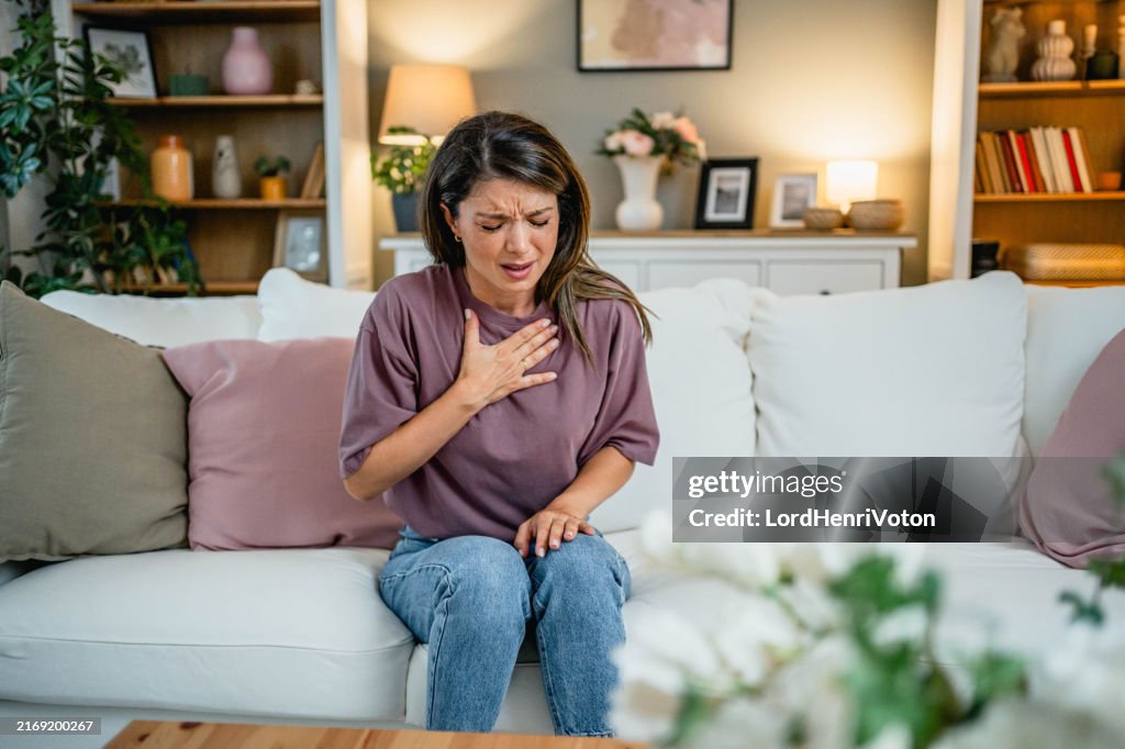 Young woman suffering from chest pain