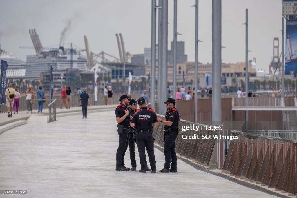 Mossos police officers are seen on surveillance duties at...