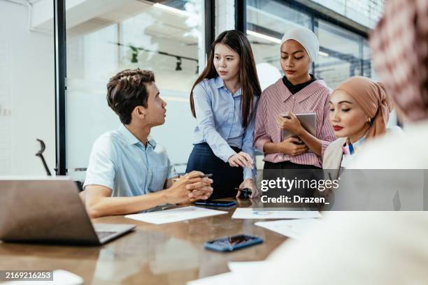 a diverse group of professionals engaged in a collaborative business meeting in a modern office environment. - hierarquia de corporação imagens e fotografias de stock