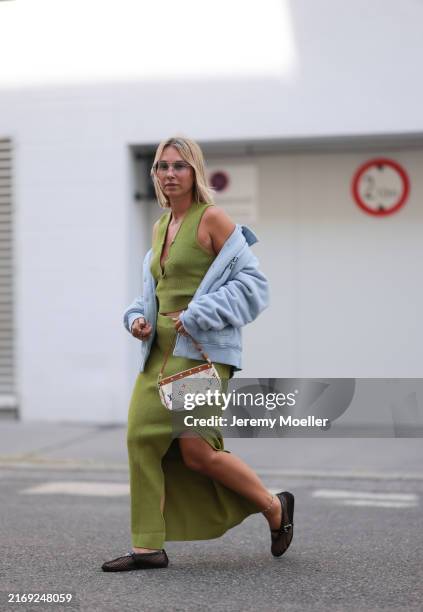 Karin Teigl seen wearing silver tinted aviator glasses, Van Cleef & Arpels Alhambra gold / green necklace, H&M green knit top, matching H&M green...