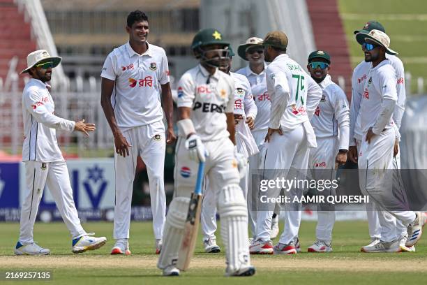 Bangladesh's Nahid Rana celebrates with teammates after taking the wicket of Pakistan's Saud Shakeel during the fourth day of the second and last...