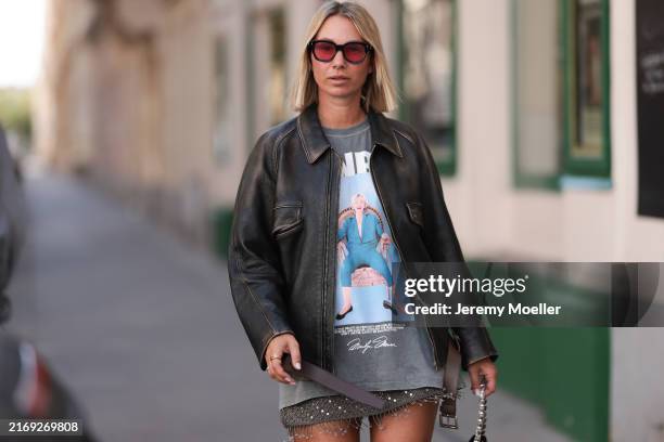 Karin Teigl seen wearing Jacque Marie Mage black sunglasses with red lenses, Zara grey washed "Monroe" print sleeveless oversized t-shirt, Zara grey...