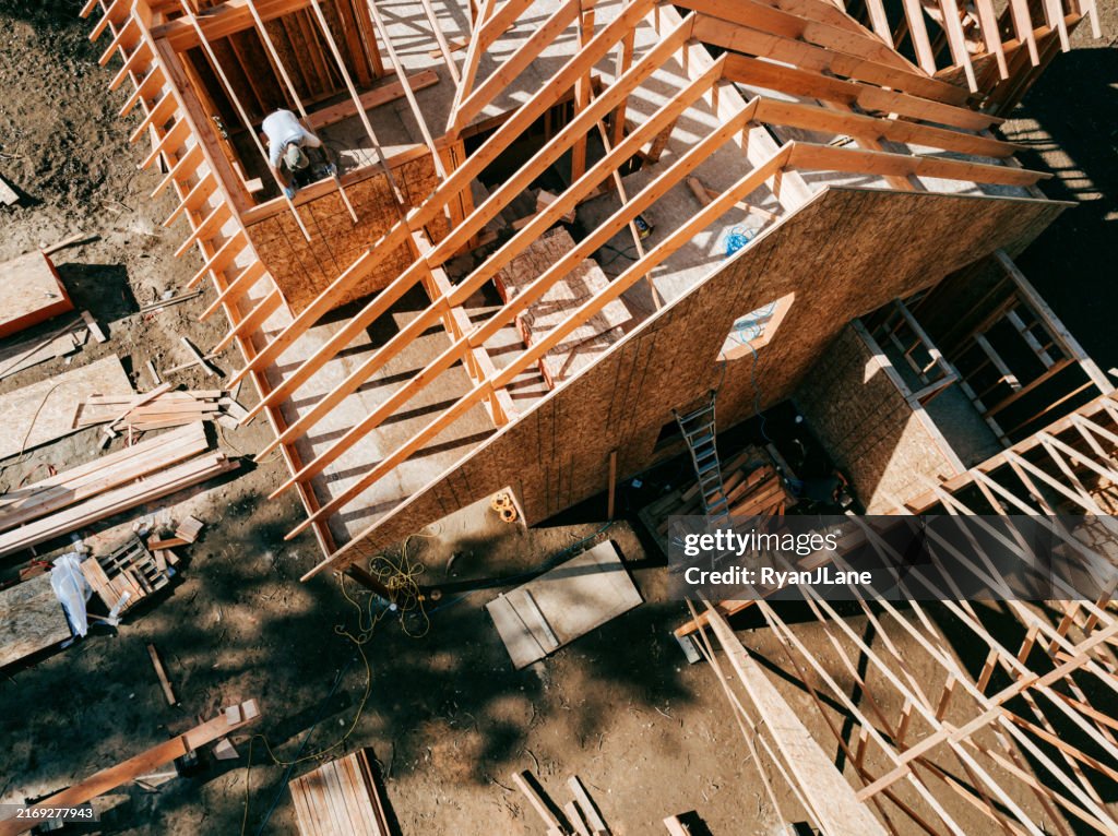 Construction Crew Putting Up Framing of New Home