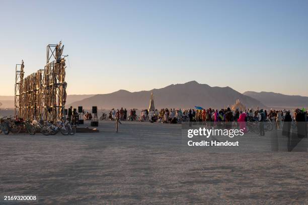 This handout image provided by Ukrainian Witness, crowds gather as Ukrainian DJ Tapolsky performs in front of the 'I'm Fine' Sculpture by Ukrainian...