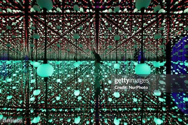 Visitor walks through the Infinity Room exhibit during the media preview of Bubble Planet: An Immersive Experience in Singapore, on September 2,...