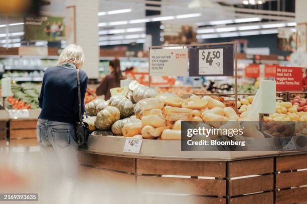 Customer selects a pumpkin at a Coles supermarket in Melbourne, Australia, on Monday, Sept. 2, 2024. Coles Group Ltd. Has reported its net income for...