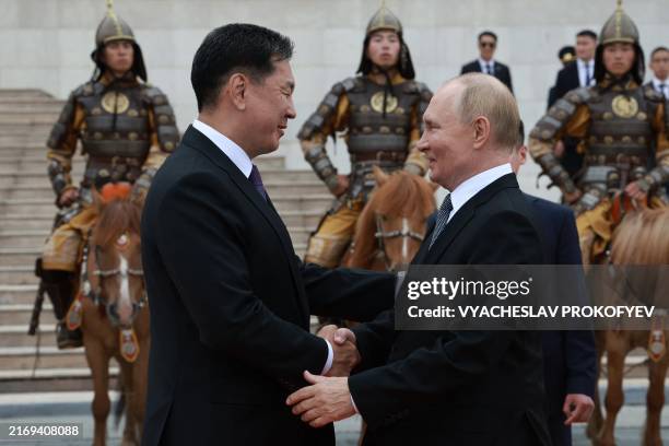 In this pool photograph distributed by the Russian state agency Sputnik, Russia's President Vladimir Putin and Mongolia's President Ukhnaagiin...