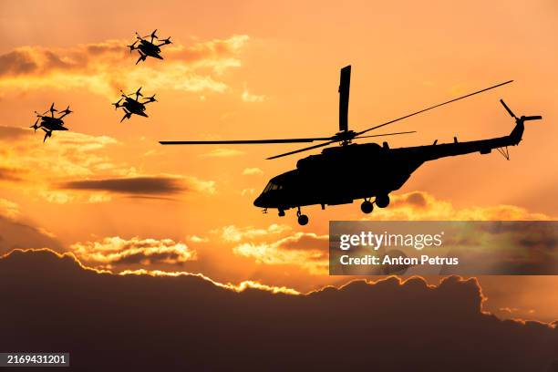 fpv kamikaze drone and military helicopter at sunset sky - exercício militar imagens e fotografias de stock