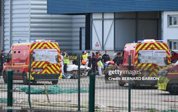 Firefighters handle the bodies of migrants who died trying to cross the Channel to England in Boulogne-sur-Mer, northern France on September 3, 2024....
