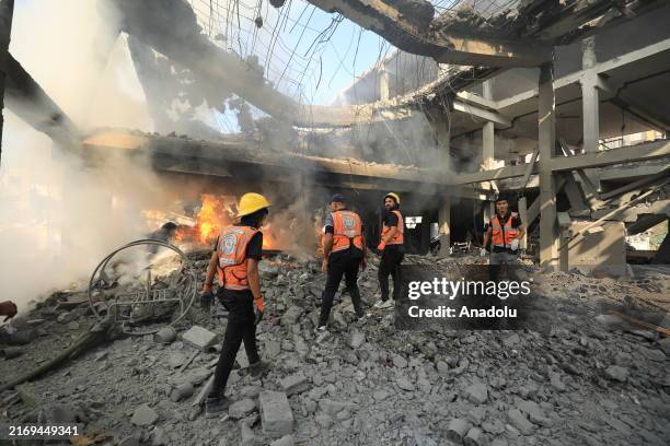 Palestinian residents and civil defense teams respond to a fire as a result of an Israeli attack on Jabalia refugee camp in Jabalia, Gaza on...