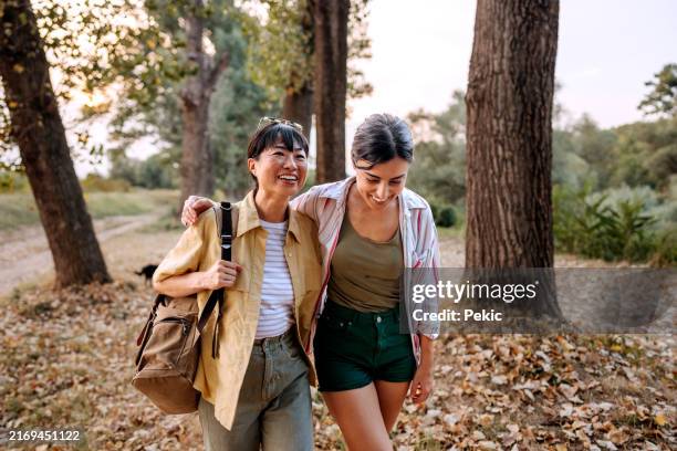 two female friends spending day together in nature - women friends stock pictures, royalty-free photos & images