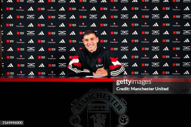 Manuel Ugarte of Manchester United poses after signing for the club at Carrington Training Ground on August 30, 2024 in Manchester, England.