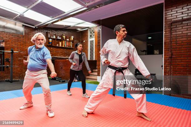 fight instructor talking with students during exercise class at gym - judo bildbanksfoton och bilder
