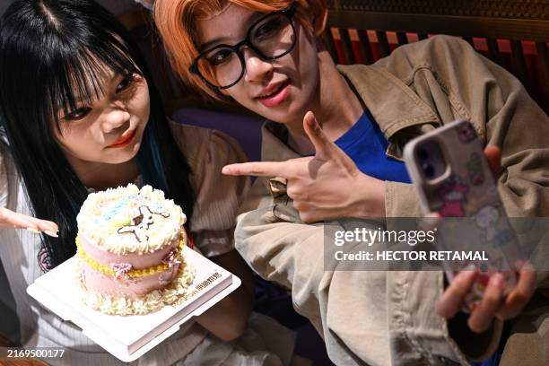 This photo taken on August 14, 2024 shows cosplayer Xu Yunting , dressed as Jesse, a male character from the video game 'Light and Night', and Feng...