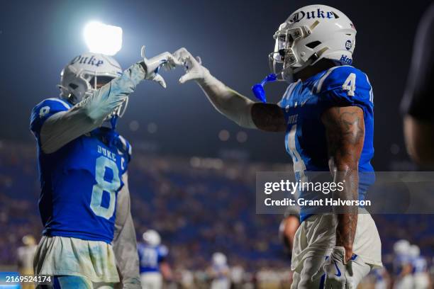 Eli Pancol celebrates with Jordan Moore of the Duke Blue Devils after scoring a touchdown against the Elon Phoenix during the second half of the game...