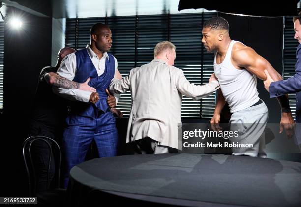 Anthony Joshua and Daniel Dubois have to be held apart during filming for Joshua v Dubois Face Off prior to the Press Conference on June 26, 2024 in...