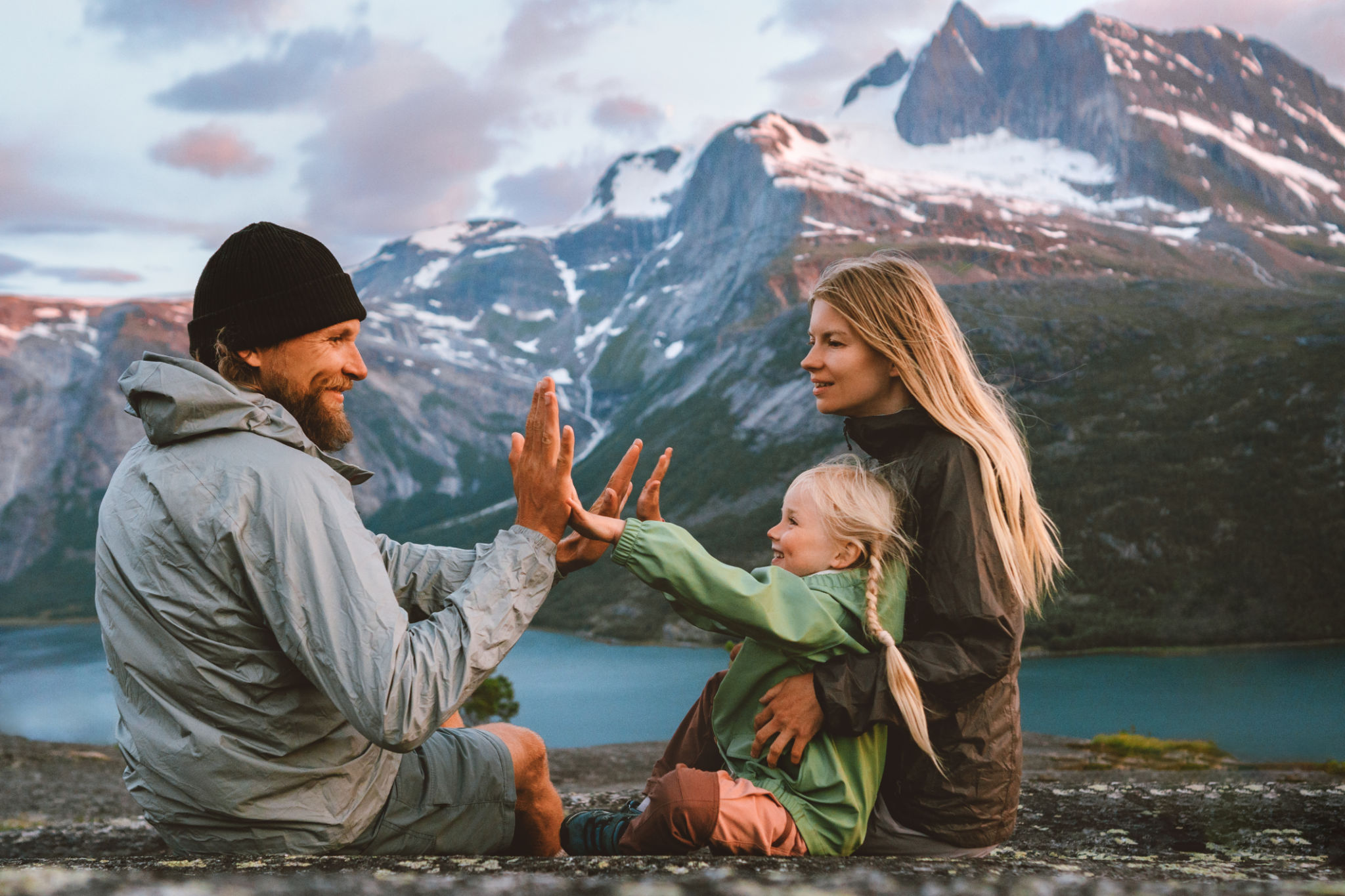Family having fun outdoor traveling together in Norway mountains: mother, father and child on summer vacations hiking adventure trip healthy lifestyle parents playing with kid Family having fun outdoor traveling together in Norway mountains: mother, father and child on summer vacations hiking adventure trip healthy lifestyle parents playing with kid