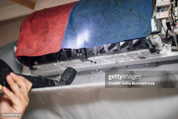 close-up of process of cleaning air outlets of indoor climate control apparatus using steam generator by unrecognizable man. - respiratory protection construction stock pictures, royalty-free photos & images