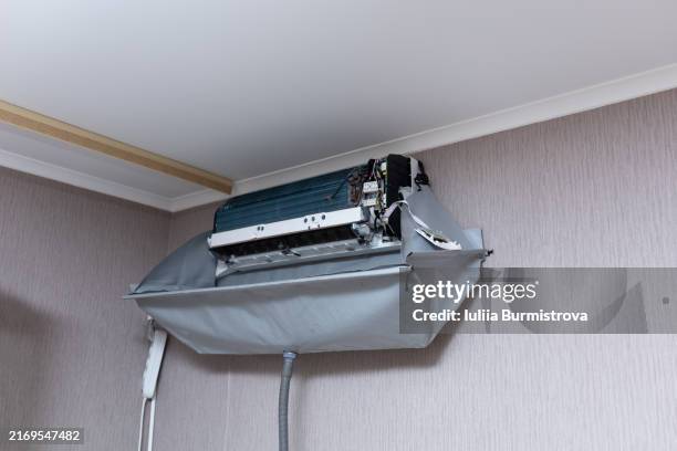 disassembled air conditioner hanging in corner of room before cleaning. - respiratory protection construction stock pictures, royalty-free photos & images