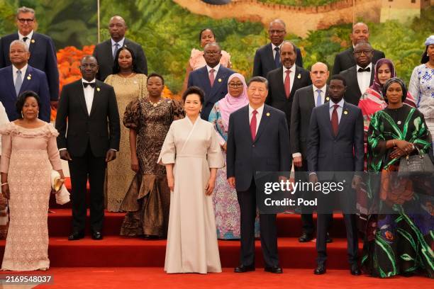 China's President Xi Jinping and his wife Peng Liyuan stand with leaders from African nations pose for a group photo ahead of the dinner reception of...