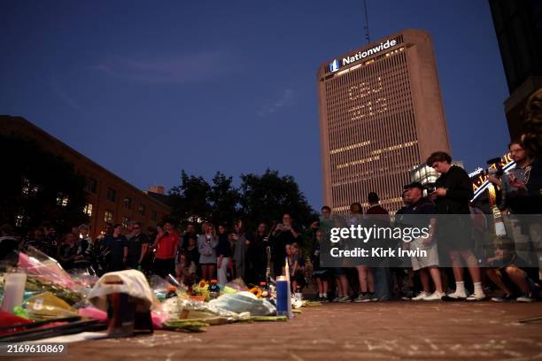 The Nationwide Insurance building is lit up with "CBJ" during a candlelight vigil in remembrance of Johnny and Matthew Gaudreau at Nationwide Arena...
