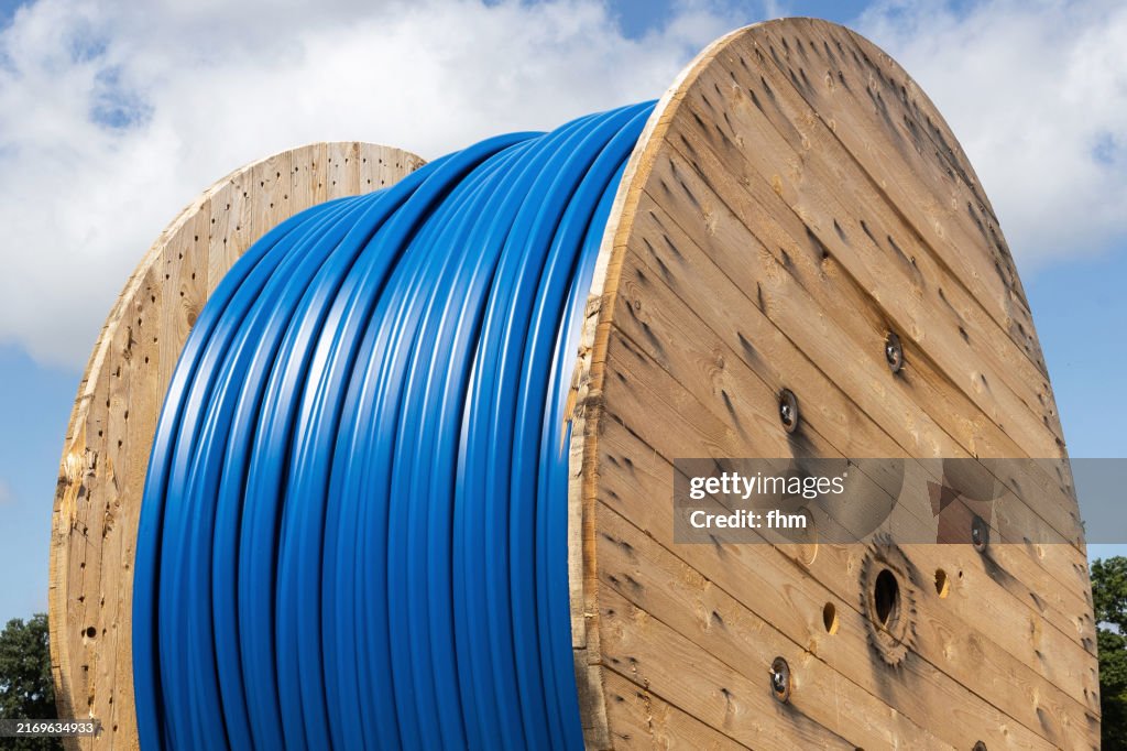 Rolled up blue cabel on a cable drum