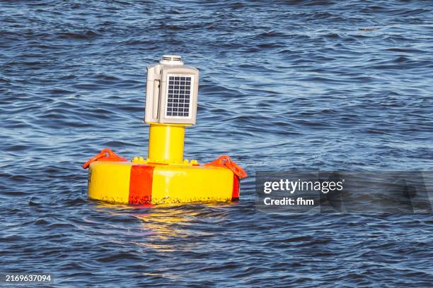 buoy in the water with solar panel - boje stock-fotos und bilder