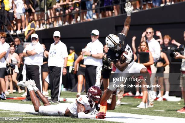 Sedrick Alexander of the Vanderbilt Commodores breaks a tackle for a touchdown during the second half of the game against the Virginia Tech Hokies at...