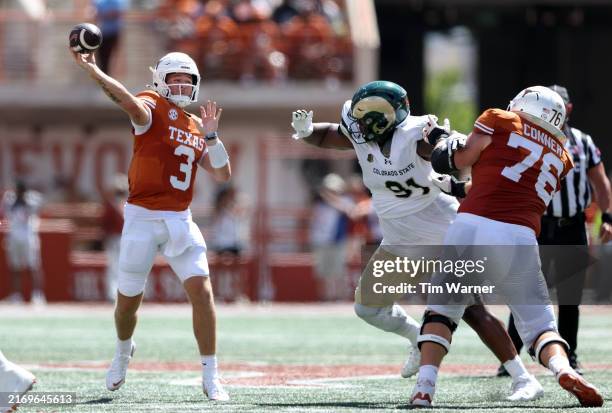 Quinn Ewers of the Texas Longhorns throws a pass in the second quarter under pressure by James Mitchell of the Colorado State Rams at Darrell K...