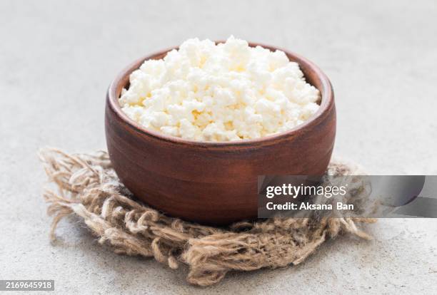 freshly made cottage cheese in a clay bowl. on a linen napkin. rustic style. close-up - cottage cheese stock pictures, royalty-free photos & images