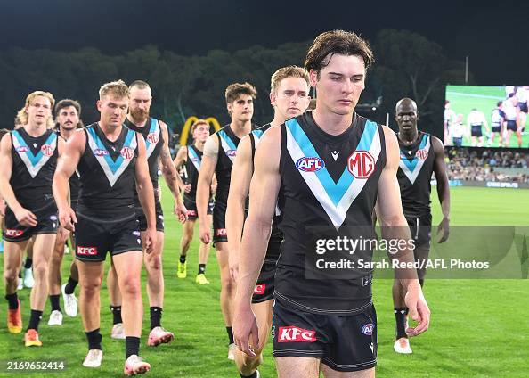 Dis Rozee Connor Rozee of the Power leads his team off after the defeat during ...