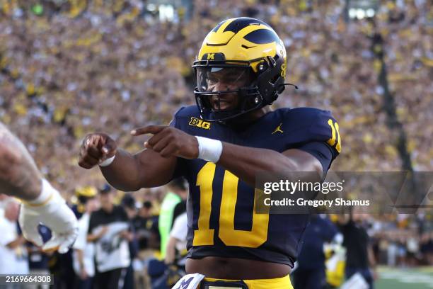 Alex Orji of the Michigan Wolverines celebrates a first half touchdown throw while playing the Fresno State Bulldogs at Michigan Stadium on August...